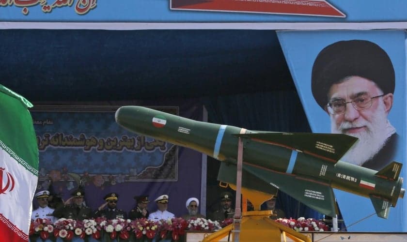 Caminhão militar transportando mísseis diante do retrato do líder supremo do Irã, aiatolá Ali Khamenei. (Foto: Getty Images)