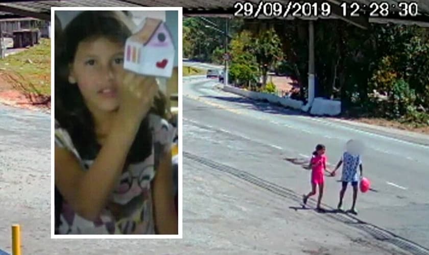 A menina Raíssa de mãos dadas com adolescente, em Perus. (Foto: Reprodução/TV Globo)